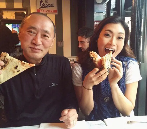 Catherine and her dad having a bite of pizza together at Seoul Korea