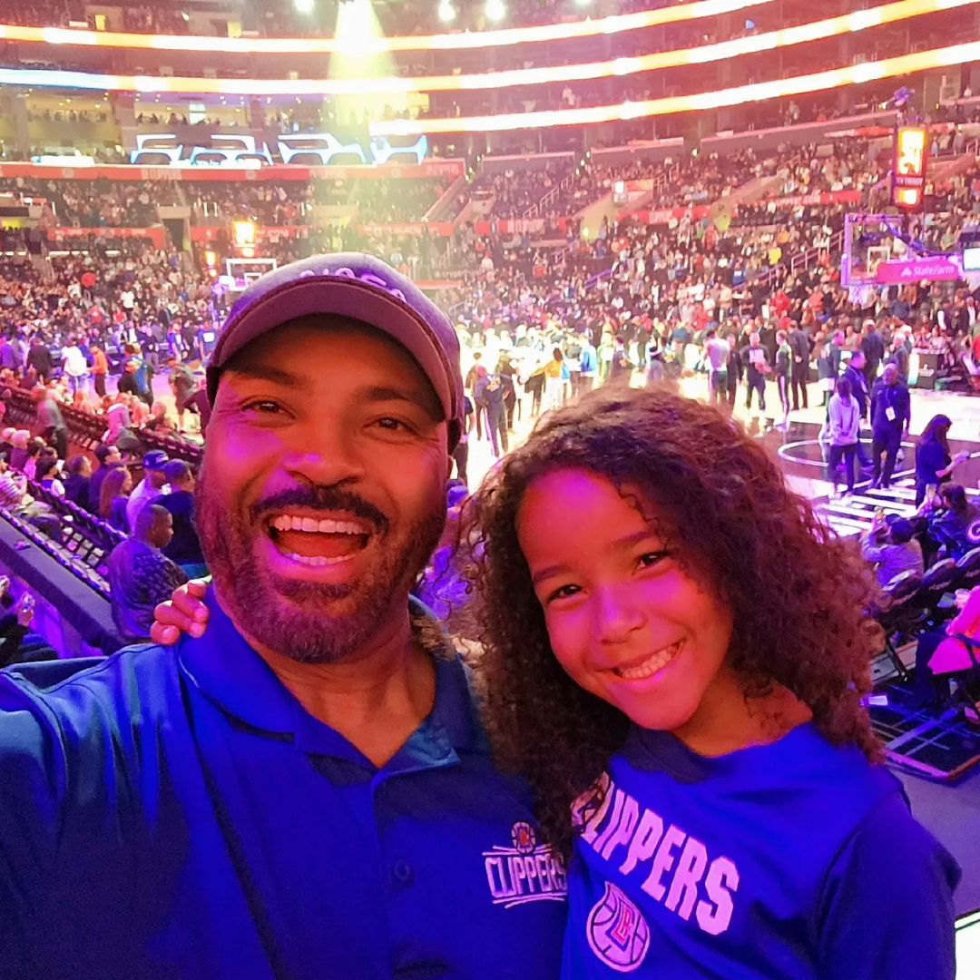 Daddy Earl with his daughter enjoying at an NBA game 